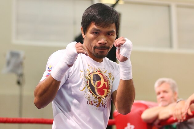 MACAU - NOVEMBER 21:  Manny Pacquiao trains while trainer Freddie Roach looks on during a workout session at The Venetianon November 21, 2014 in Macau, Macau.  (Photo by Chris Hyde/Getty Images)