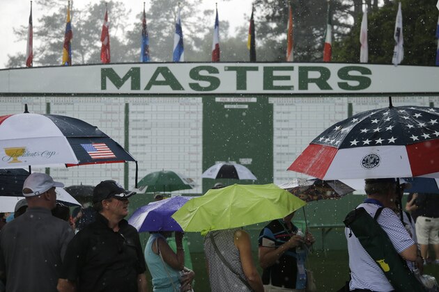 Spectators leave the course at Augusta National Golf Club during a rain storm during a practice round for the Masters golf tournament Tuesday, April 7, 2015, in Augusta, Ga. (AP Photo/Matt Slocum)