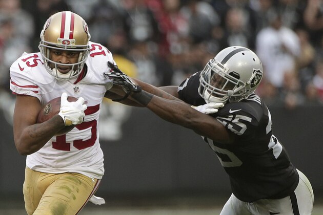 San Francisco 49ers wide receiver Michael Crabtree (15) stiff arms Oakland Raiders cornerback D.J. Hayden during the third quarter of an NFL football game in Oakland, Calif., Sunday, Dec. 7, 2014. (AP Photo/Marcio Jose Sanchez)