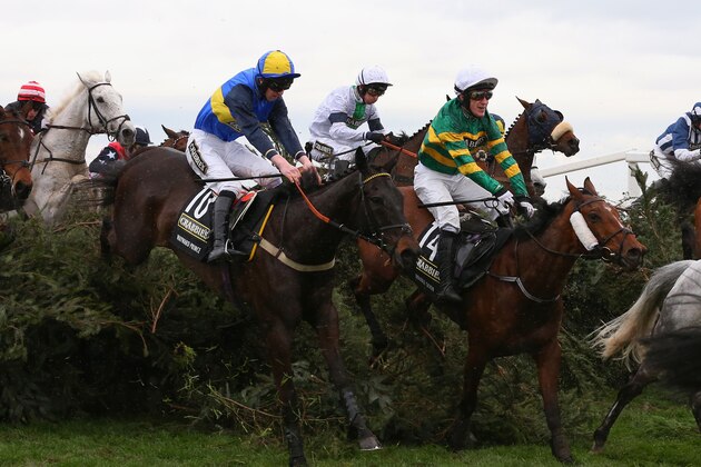 LIVERPOOL, ENGLAND - APRIL 05:  Pineau De Re ridden by Leighton Aspell (centre,white cap) jumps the The Chair amongst Double Seven ridden by A.P McCoy (14) and Wayward Prince ridden by Jack Doyle (10) on their way to victory during the Crabbie's Grand National Steeple Chase at Aintree Racecourse on April 5, 2014 in Liverpool, England.  (Photo by Alex Livesey/Getty Images)