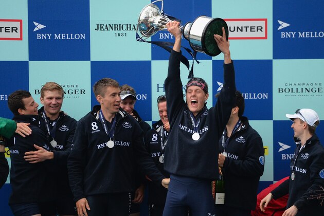 LONDON, ENGLAND - APRIL 06:  Karl Hudspith of Oxford rises the trophy as he celebrates their victory with his team mates during the BNY Mellon Oxford v Cambridge University Boat Race 2014 on the Thames on April 6, 2014 in London, England.  (Photo by Christopher Lee/Getty Images)