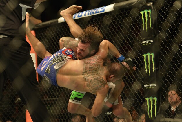 Apr 4, 2015; Fairfax, VA, USA; Clay Guida (red gloves) fights Robbie Peralta (blue gloves) during UFC Fight Night at Patriot Center. Mandatory Credit: Tommy Gilligan-USA TODAY Sports