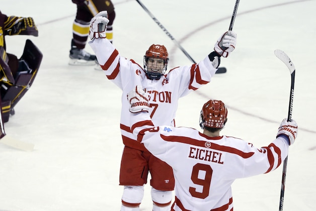 Boston University forward Evan Rodrigues (17) celebrates his goal with teammate Jack Eichel (9) as University of Minnesota Duluth goalie Kasimir Kaskisuo (33) reacts in the first period of an NCAA college hockey regional championship game in Manchester, N.H., Saturday, March 28, 2015. (AP Photo/Elise Amendola)