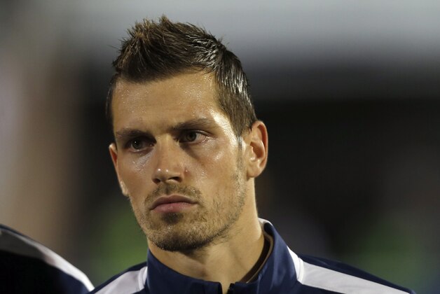 France's Morgan Schneiderlin stands during the playing of his country's national anthem before the start of their international friendly soccer match against Serbia, in Belgrade, Serbia, Sunday, Sept. 7, 2014. (AP Photo/Darko Vojinovic)