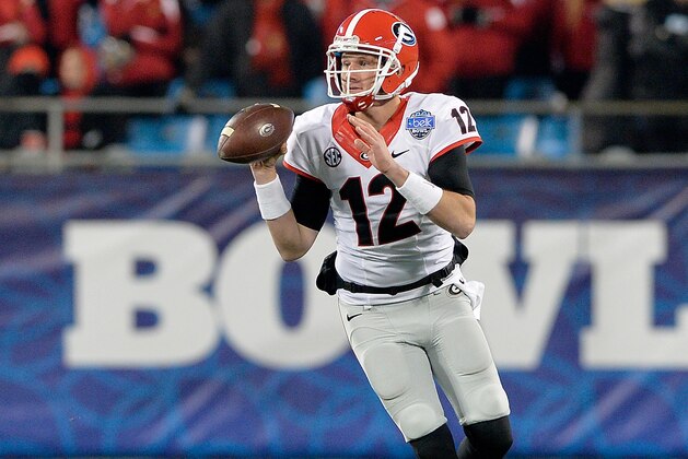 CHARLOTTE, NC - DECEMBER 30:  Brice Ramsey #12 of the Georgia Bulldogs rolls out against the Louisville Cardinals during the Belk Bowl at Bank of America Stadium on December 30, 2014 in Charlotte, North Carolina. Georgia won 37-14.  (Photo by Grant Halverson/Getty Images)