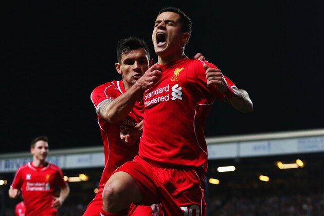 BLACKBURN, ENGLAND - APRIL 08:  Philippe Coutinho of Liverpool (10) celebrates with Dejan Lovren as he scores their first goal during the FA Cup Quarter Final Replay match between Blackburn Rovers and Liverpool at Ewood Park on April 8, 2015 in Blackburn, England.  (Photo by Jan Kruger/Getty Images)
