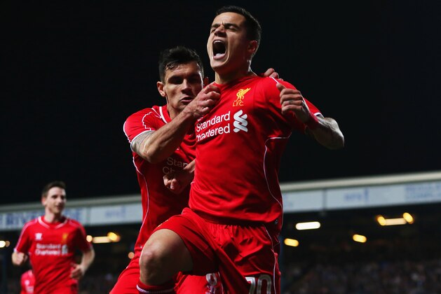 BLACKBURN, ENGLAND - APRIL 08:  Philippe Coutinho of Liverpool (10) celebrates with Dejan Lovren as he scores their first goal during the FA Cup Quarter Final Replay match between Blackburn Rovers and Liverpool at Ewood Park on April 8, 2015 in Blackburn, England.  (Photo by Jan Kruger/Getty Images)