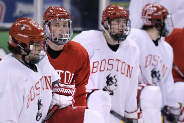 Boston University forward Jack Eichel, second from left, takes a break with teammates during an NCAA hockey practice before the Frozen Four tournament in Boston, Wednesday, April 8, 2015. (AP Photo/Charles Krupa)