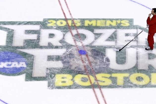 Boston University head coach David Quinn watches his players during an NCAA hockey practice before the Frozen Four tournament in Boston, Wednesday, April 8, 2015.   (AP Photo/Charles Krupa)