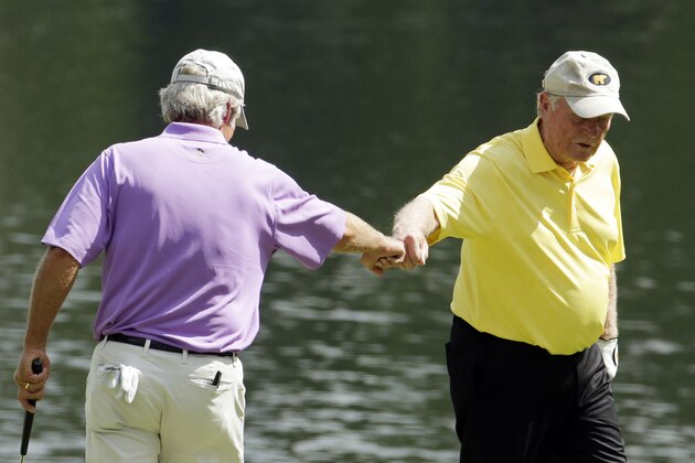 Ben Crenshaw pump fists with Jack Nicklaus on the third hole during the Par 3 contest at the Masters golf tournament Wednesday, April 8, 2015, in Augusta, Ga. (AP Photo/Charlie Riedel)