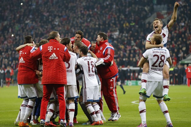 Bayern's Rafinha, right top, from Brazil and Holger Badstuber, right bottom, celebrate after winning 5-3 in the penalty shoot-out of the German soccer cup (DFB Pokal) quarterfinal match between Bayer 04 Leverkusen and Bayern Munich Wednesday, April 8, 2015 in Leverkusen, Germany. (AP Photo/Frank Augstein)