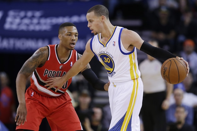 Golden State Warriors' Stephen Curry (30) in action against the Portland Trail Blazers' Damian Lillard during an NBA basketball game on Sunday, Jan. 26, 2014, in Oakland, Calif. (AP Photo/Marcio Jose Sanchez)
