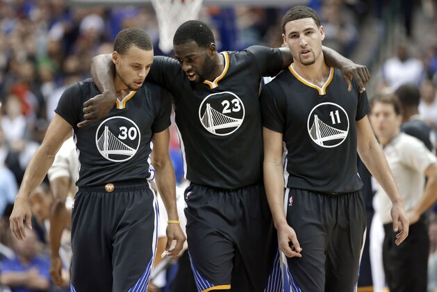 Golden State Warriors guard Stephen Curry (30), Draymond Green (23) and Klay Thompson (11) walk up court during the second half of an NBA basketball game against the Dallas Mavericks, Saturday, Dec. 13, 2014, in Dallas. Curry had 29-points, Green had 20-points and Thompson had 25-points in the 105-98 Warriors win. (AP Photo/Tony Gutierrez)