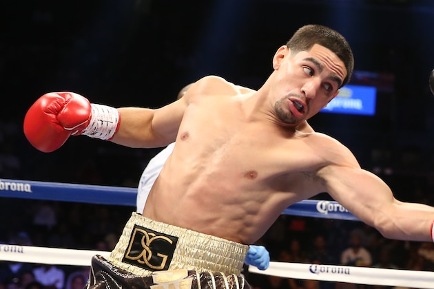 BROOKLYN, NY - AUGUST 9: Danny Garcia (Brown/Gold trunks) lands a left to the body of Rod Salka (Black/Gold trunks) during their fight at the Barclays Center on August 9, 2014 in Brooklyn, New York. (Photo by Ed Mulholland/Getty Images)