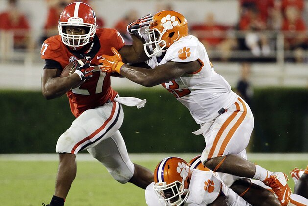 Georgia's Nick Chubb, left, breaks free from the tackle of Clemson's Stephone Anthony, to run for a touchdown in the second half of an NCAA college football game, Saturday, Aug. 30, 2014, in Athens, Ga. (AP Photo/David Goldman)
