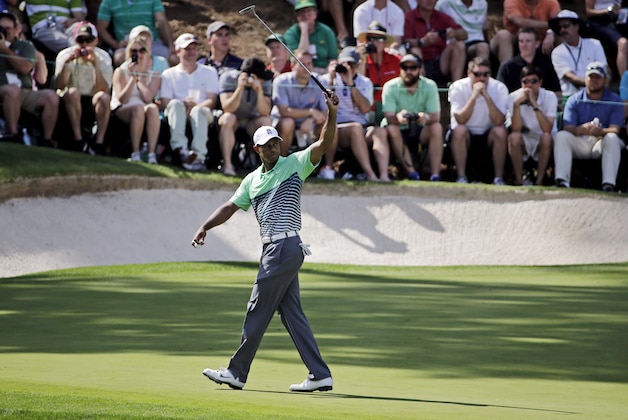 Tiger Woods waves his putter during the Par 3 contest at the Masters golf tournament Wednesday, April 8, 2015, in Augusta, Ga. (AP Photo/David J. Phillip)