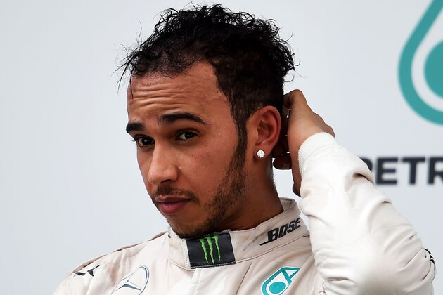 KUALA LUMPUR, MALAYSIA - MARCH 29:  Lewis Hamilton of Great Britain and Mercedes GP looks on as he stands on the podium aftrer finishing second in the Malaysia Formula One Grand Prix at Sepang Circuit on March 29, 2015 in Kuala Lumpur, Malaysia.  (Photo by Lars Baron/Getty Images)