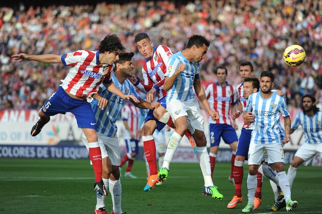 MADRID, SPAIN - NOVEMBER 22:  Tiago Mendes (L) of Club Atletico de Madrid scores his team's opening goal during the La Liga match between Club Atletico de Madrid and Malaga CF at Vicente Calderon Stadium on November 22, 2014 in Madrid, Spain.  (Photo by Denis Doyle/Getty Images)