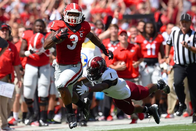 Sep 20, 2014; Athens, GA, USA; Georgia Bulldogs running back Todd Gurley (3) runs down the sideline against Troy Trojans defensive back Montres Kitchens (1) during the first quarter at Sanford Stadium. Mandatory Credit: Dale Zanine-USA TODAY Sports