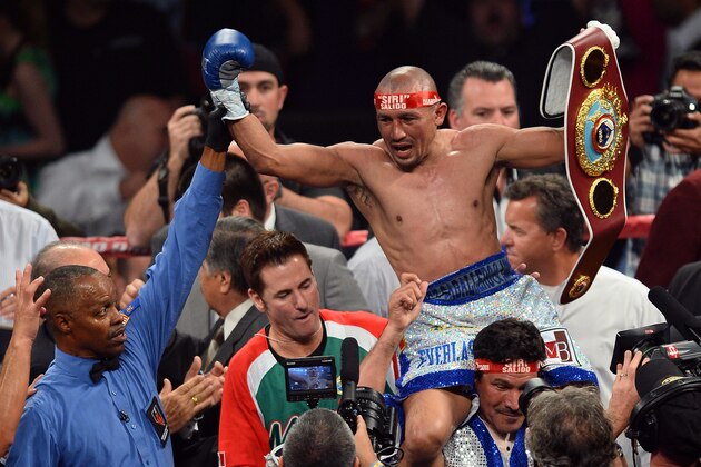 LAS VEGAS, NV - OCTOBER 12:  Referee Kenny Bayless holds up the hand of Orlando Salido as he celebrates his seventh-round TKO victory over Orlando Cruz in their WBO featherweight championship bout at the Thomas & Mack Center on October 12, 2013 in Las Vegas, Nevada.  (Photo by Ethan Miller/Getty Images)