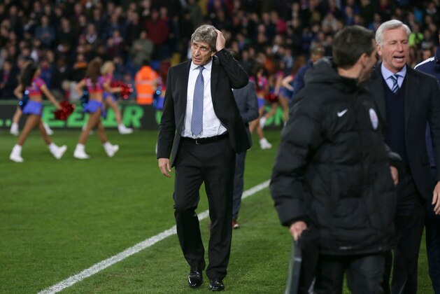 Manchester City manager Manuel Pellegrini, left, arrives ahead of the English Premier League soccer match between Crystal Palace and Manchester City at Selhurst Park Stadium, London, Monday, April 6, 2015. (AP Photo/Tim Ireland)