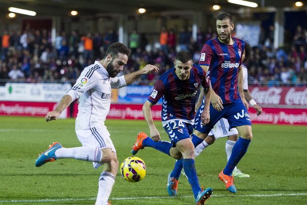 EIBAR, SPAIN - NOVEMBER 22: Daniel Carvajal of Real Madrid duels for the ball with Abraham MInero of SD Eibar during the La Liga match between SD Eibar and Real Madrid at Ipurua Municipal Stadium on November 22, 2014 in Eibar, Spain. (Photo by Juan Manuel Serrano Arce/Getty Images)