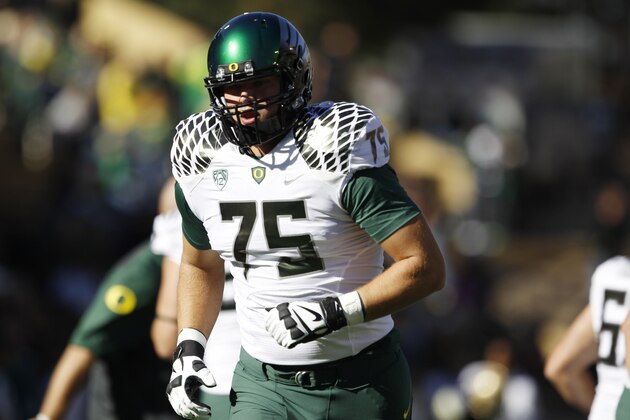 Oregon offensive lineman Jake Fisher warms up before facing Colorado in the first quarter of an NCAA college football game in Boulder, Colo., on Saturday, Oct. 5, 2013. (AP Photo/David Zalubowski)