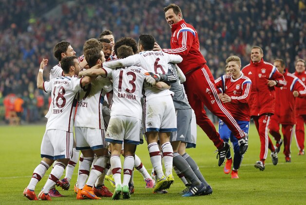 Bayern players celebrate after winning 5-3 in the penalty shoot-out of the German soccer cup (DFB Pokal) quarterfinal match between Bayer 04 Leverkusen and Bayern Munich Wednesday, April 8, 2015 in Leverkusen, Germany. (AP Photo/Frank Augstein)