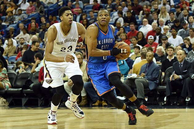 NEW ORLEANS, LA - DECEMBER 02:  Russell Westbrook #0 of the Oklahoma City Thunder drives around Anthony Davis #23 of the New Orleans Pelicans during the second quarter of a game at the Smoothie King Center on December 2, 2014 in New Orleans, Louisiana. New Orleans won the game 112-104. NOTE TO USER: User expressly acknowlesges and agrees that by downloading and or using this photograph, User is consenting to the terms and conditions of the Getty Images License Agreement.  (Photo by Stacy Revere/Getty Images)