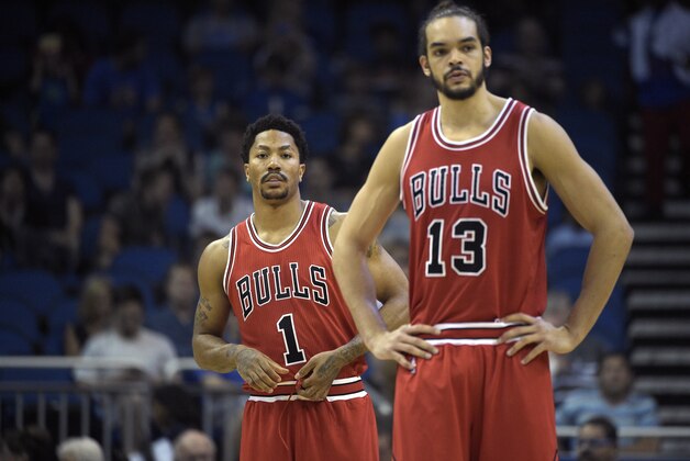 Chicago Bulls guard Derrick Rose (1) and center Joakim Noah (13) stand on the court during the first half of an NBA basketball game against the Orlando Magic in Orlando, Fla., Wednesday, April 8, 2015.(AP Photo/Phelan M. Ebenhack)