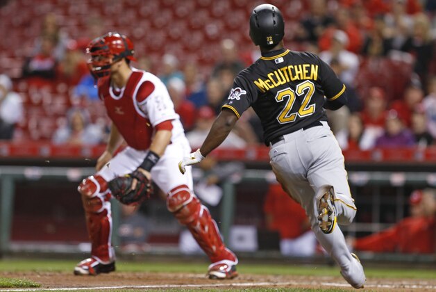 Pittsburgh Pirates' Andrew McCutchen (22) runs home to score on a single by Corey Hart as Cincinnati Reds catcher Devin Mesoraco waits for the throw during the seventh inning of a baseball game Wednesday, April 8, 2015, in Cincinnati. (AP Photo/Gary Landers)