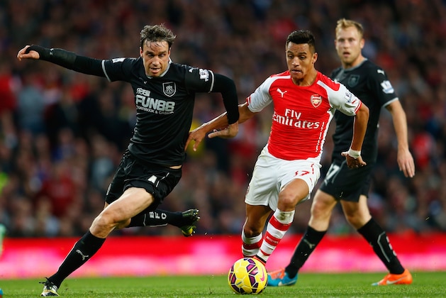 LONDON, ENGLAND - NOVEMBER 01: Michael Duff of Burnley and Alexis Sanchez of Arsenal (R) in action during the Barclays Premier League match between Arsenal and Burnley at Emirates Stadium on November 1, 2014 in London, England.  (Photo by Julian Finney/Getty Images)