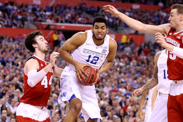 INDIANAPOLIS, IN - APRIL 04: Karl-Anthony Towns #12 of the Kentucky Wildcats handles the ball against Frank Kaminsky #44 of the Wisconsin Badgers in the second half during the NCAA Men's Final Four Semifinal at Lucas Oil Stadium on April 4, 2015 in Indianapolis, Indiana.  (Photo by Andy Lyons/Getty Images)