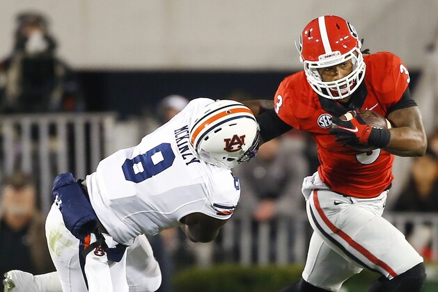 Georgia running back Todd Gurley (3) tries to get past Auburn linebacker Cassanova McKinzy (8) in the first half of an NCAA college football game Saturday, Nov. 15, 2014, in Athens, Ga. (AP Photo/John Bazemore)