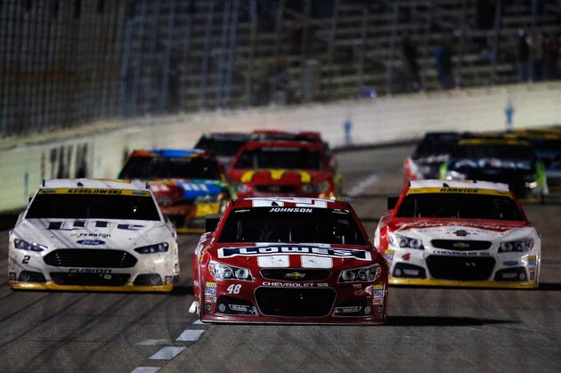FORT WORTH, TX - NOVEMBER 02:  Jimmie Johnson, driver of the #48 Lowe's Red Vest Chevrolet, races ahead of Brad Keselowski, driver of the #2 Miller Lite Ford, and Kevin Harvick, driver of the #4 Budweiser Chevrolet, during the NASCAR Sprint Cup Series AAA Texas 500 at Texas Motor Speedway on November 2, 2014 in Fort Worth, Texas.  (Photo by Tom Pennington/Getty Images for Texas Motor Speedway)