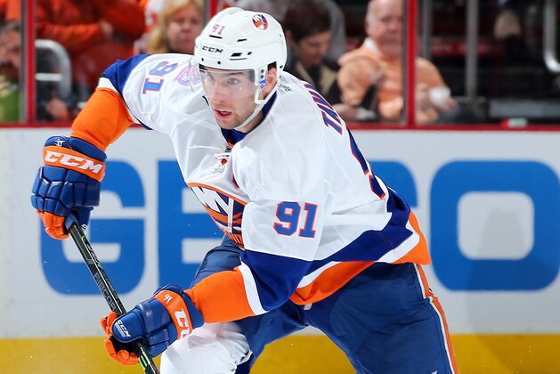 PHILADELPHIA, PA - APRIL 07:  John Tavares #91 of the New York Islanders takes the puck in the third period against the Philadelphia Flyers on April 7, 2015 at the Wells Fargo Center in Philadelphia, Pennsylvania.The Philadelphia Flyers defeated the New York Islanders 5-4.  (Photo by Elsa/Getty Images)