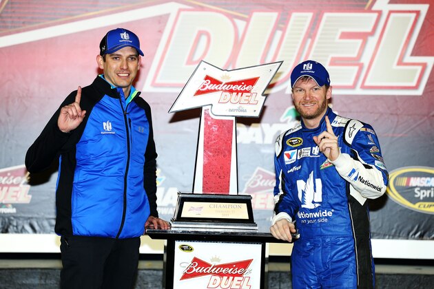 DAYTONA BEACH, FL - FEBRUARY 19:  Dale Earnhardt Jr., driver of the #88 Nationwide Chevrolet, and crew chief Greg Ives pose with the trophy in Victory Lane after winning the NASCAR Sprint Cup Series Budweiser Duel 1 at Daytona International Speedway on February 19, 2015 in Daytona Beach, Florida.  (Photo by Patrick Smith/Getty Images)
