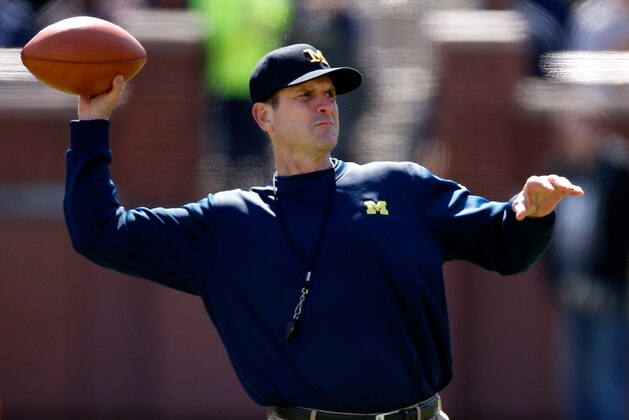 ANN ARBOR, MI - APRIL 04: Head coach Jim Harbaugh of the Michigan Wolverines throws a football during the Michigan Football Spring Game on April 4, 2015 at Michigan Stadium in Ann Arbor, Michigan.  (Photo by Gregory Shamus/Getty Images)