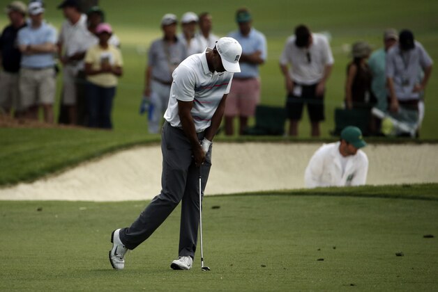 Tiger Woods reacts after his second shot on the 18th hole during the first round of the Masters golf tournament Thursday, April 9, 2015, in Augusta, Ga. (AP Photo/Charlie Riedel)