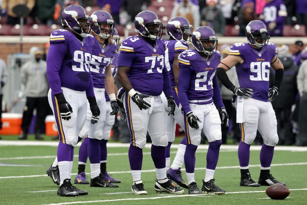 Minnesota Vikings defensive players, from left, defensive tackle Linval Joseph (98), middle linebacker Audie Cole (57), defensive tackle Sharrif Floyd (73) and  defensive end Brian Robison (96) wait during time out in the first half of an NFL football game against the Chicago Bears, Sunday, Dec. 28, 2014, in Minneapolis. (AP Photo/Jim Mone)