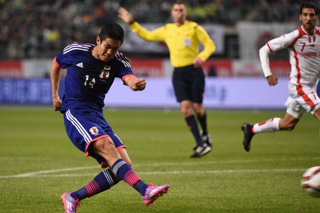 OITA, JAPAN - MARCH 27:Yoshinori Muto of Japan shoots the ball during the international friendly match between Japan and Tunisia at Oita Bank Dome on March 27, 2015 in Oita, Japan.  (Photo by Kaz Photography/Getty Images)