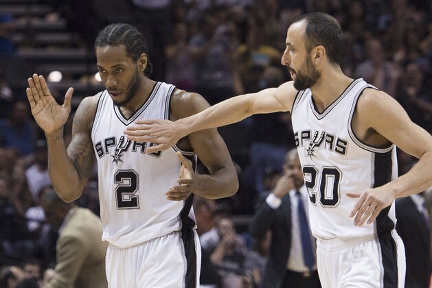 San Antonio Spurs guard Manu Ginobili (20), of Argentina, congratulates guard Kawhi Leonard on a basket during the second half of an NBA basketball game against the Houston Rockets, Wednesday, April 8, 2015, in San Antonio. San Antonio won 110-98. (AP Photo/Darren Abate)