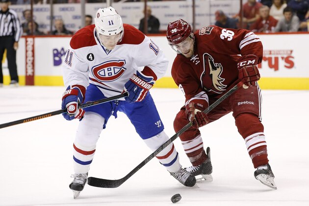 Arizona Coyotes' Mark Arcobello (36) and Montreal Canadiens' Brendan Gallagher (11) battle for the puck during the first period of an NHL hockey game Saturday, March 7, 2015, in Glendale, Ariz. (AP Photo/Ross D. Franklin)