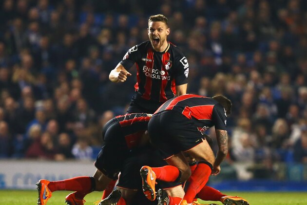 BRIGHTON, ENGLAND - APRIL 10:  Yann Kermorgant of Bournemouth (obscured) is mobbed by team mates in celebration as he scores their first goal from a free kick during the Sky Bet Championship match between Brighton & Hove Albion and AFC Bournemouth at Amex Stadium on April 10, 2015 in Brighton, England.  (Photo by Charlie Crowhurst/Getty Images)
