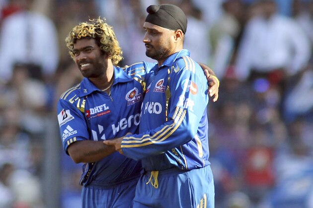 Mumbai Indians' cricketer Harbhajan Singh, right, celebrates with teammate Lasith Malinga the dismissal of Pune Warriors' Marlon Samuels during an Indian Premier League (IPL) cricket match against Mumbai Indians in Mumbai, India, Friday, April 6, 2012. (AP Photo/ Rajanish Kakade)