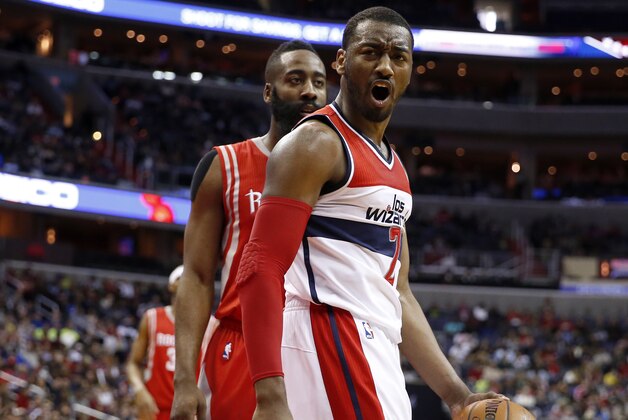 Washington Wizards guard John Wall (2) reacts in front of Houston Rockets guard James Harden in the second half of an NBA basketball game Sunday, March 29, 2015, in Washington. The Rockets won 99-91. (AP Photo/Alex Brandon)