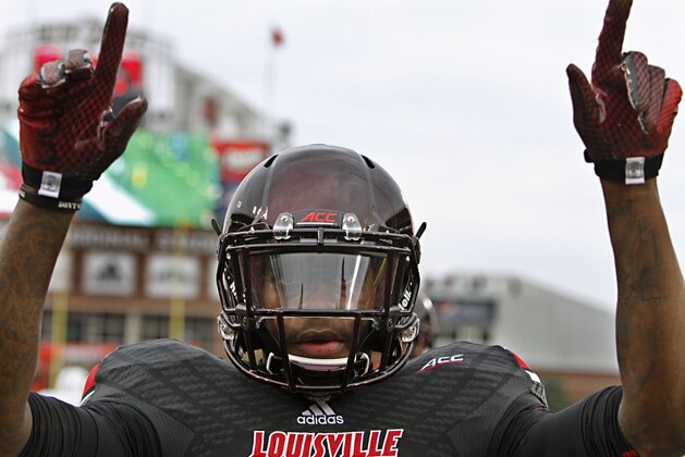 Senior wide receiver DeVante Parker celebrates after scoring on a 33-yard pass and run play against rival Kentucky in their NCAA college football game Saturday, Nov. 29, 2014, in Louisville, Ky. Louisville came from behind to beat Kentucky 44-40. (AP Photo/Garry Jones)