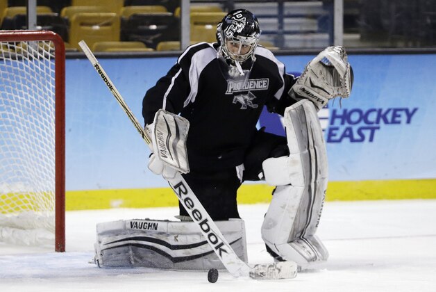 Providence goalie Jon Gillies sweeps the puck aside during practice in Boston, Friday, April 10, 2015 in preparation for the NCAA college Frozen Four men's ice hockey championship game. Providence will face Boston University on Saturday. (AP Photo/Elise Amendola)