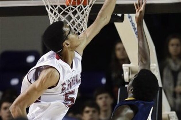 Evangelical Christian School's Skal Labissiere, left, blocks a shot by Lausanne Collegiate School's Denio Chirindja (4) in the first half of the Division II Class A high school basketball championship game on Saturday, March 2, 2013, in Nashville, Tenn. (AP Photo/Mark Humphrey)