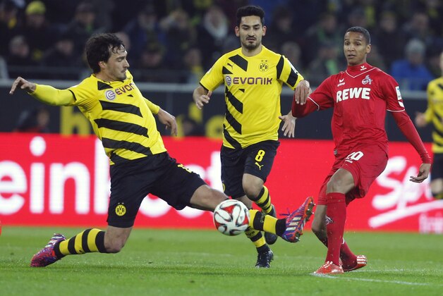 Dortmund's Mats Hummels, left, and Ilkay Gundogan, center, challenge for the ball with Cologne’s Deyverson during the German first division Bundesliga soccer match between BvB Borussia Dortmnd and 1.FC Cologne in Dortmund, Germany, Saturday, March 14, 2015. (AP Photo/Frank Augstein)